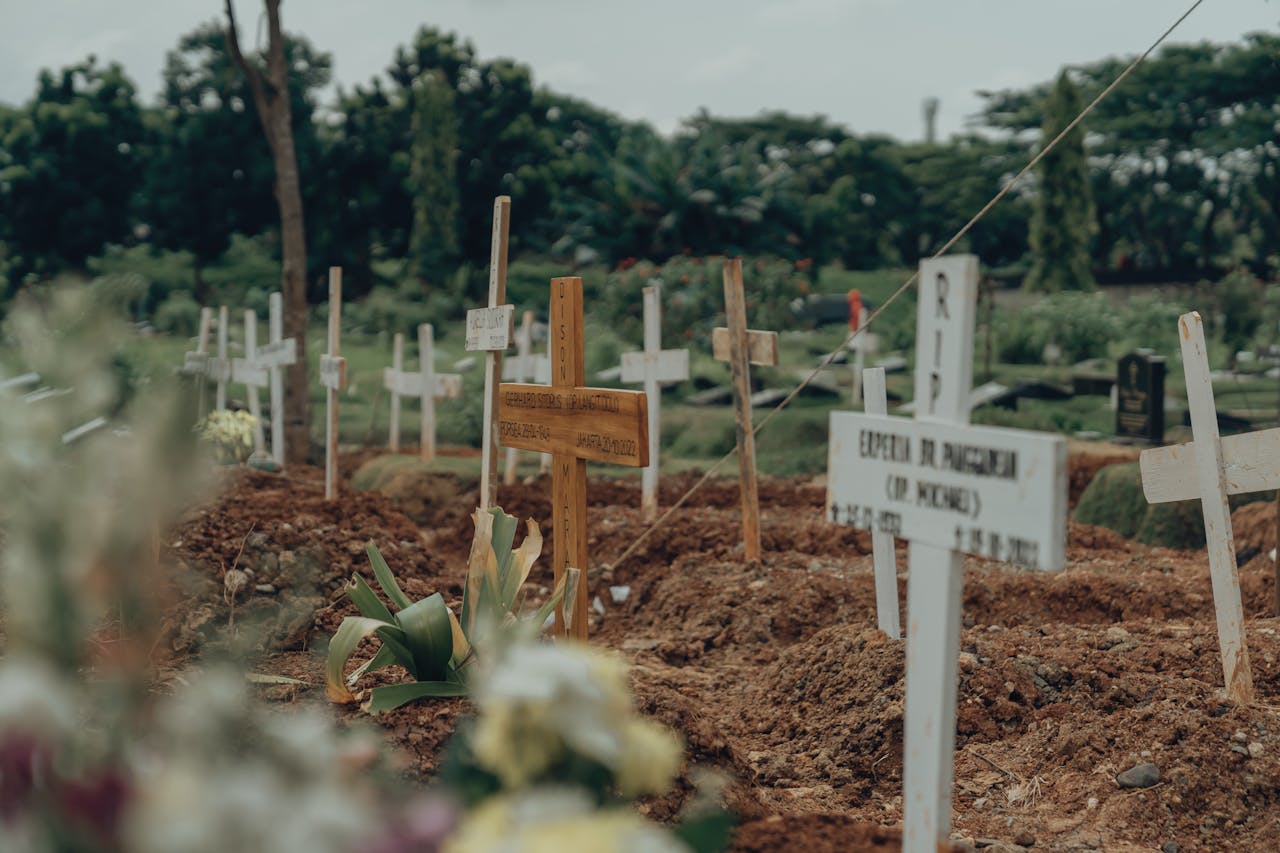 gallery-4 A serene view of wooden crosses in a Jakarta cemetery, symbolizing eternal peace.